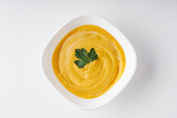 Cream soup from lentils, pumpkin, carrots on a white background