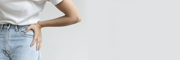 Asian Woman in Distress, Dealing with hip pain, work-related pelvic issue, Healthcare concept