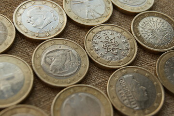 1 euro coins on natural linen fabric. Bimetallic European coins obverse.