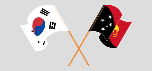 Crossed and waving flags of South Korea and Papua New Guinea