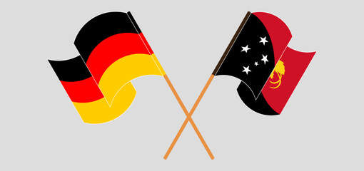 Crossed and waving flags of Germany and Papua New Guinea