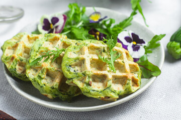 Zucchini waffles with arugula in a bowl
