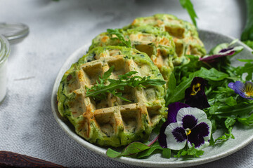Zucchini waffles with arugula in a bowl
