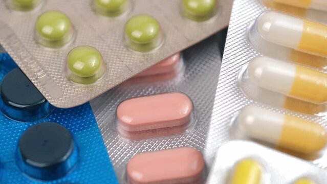 closeup with rotating pills and medicines with blister packaging. concept of medicine, pharmacy, healthcare, pharmaceutical industry. top view.