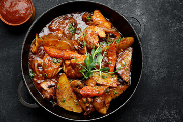 Fototapeta premium Stewed potatoes with sauce, mushrooms and vegetables