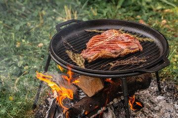 Beef steaks on the grill with flames, banner, menu, recipe place for text, top view