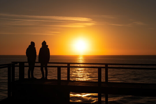 silhouette a couple of friends and sea sunset sun generative ai