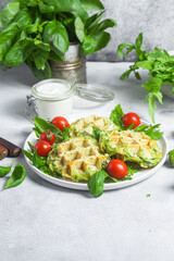 Zucchini waffles with arugula and cherry tomatoes in a plate