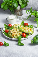 Zucchini waffles with arugula and cherry tomatoes in a plate