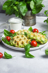 Zucchini waffles with arugula and cherry tomatoes in a plate