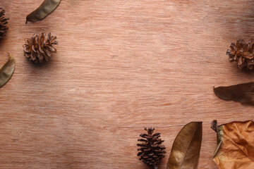 Dry leaves on wooden textured background