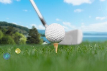 Golf balls on the green course with clubs, sport concept