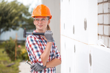 Insulation of the house with polyfoam. The worker is checking with the construction level the...