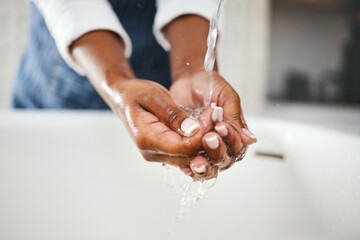 Woman cleaning hands, water and hygiene in bathroom, safety from bacteria and germs, disinfection...