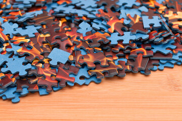 Colorful Peaces of a Mixed Jigsaw Puzzle Lie on the Wooden Table - Strategy and Solving Problem...