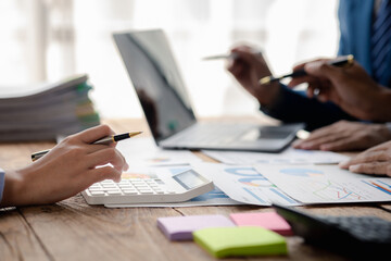 The sales department is having a monthly summary meeting to bring it to the department manager, they are verifying the correctness of the documents that are prepared before bringing in to the manager