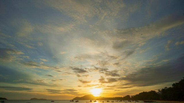 ..time lapse clouds moving in yellow sky in sunrise moving slowly above islands at Rawai beach Phuket. .Nature video High quality footage..Scene of Colorful sky sunset with cloud background..