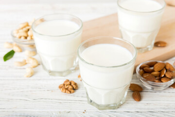 Set or collection of various vegan milk almond, cashew, on table background. Vegan plant based milk...