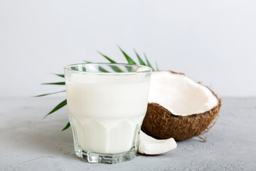 coconut products on white wooden table background. Dairy free milk substitute drink, Flat lay...