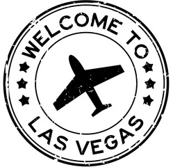 Grunge black welcome to las vegas with airplane icon round rubber seal stamp on white background © bankrx