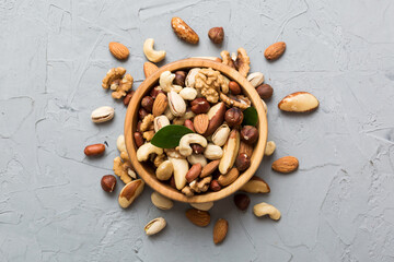 mixed nuts in bowl. Mix of various nuts on colored background. pistachios, cashews, walnuts, hazelnuts, peanuts and brazil nuts