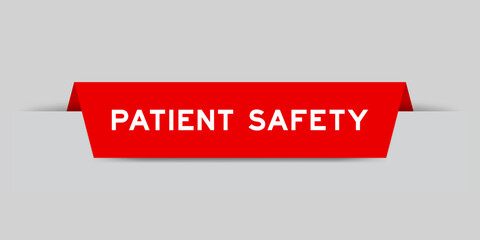 Red color inserted label with word patient safety on gray background
