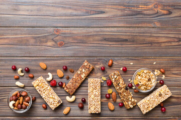 Various granola bars on table background. Cereal granola bars. Superfood breakfast bars with oats, nuts and berries, close up. Superfood concept