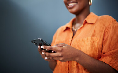 Typing, happy and hands with a phone on a dark background for communication or social media. Smile,...