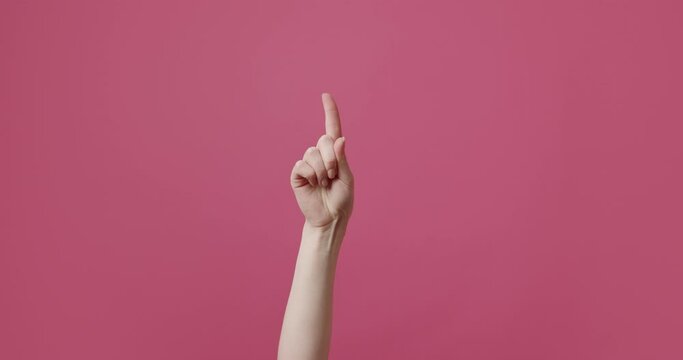 A woman's hand gesticulates, shows a sign that it is not possible, wags its finger in different parts. Access forbidden. Shaking finger saying no. Finger signal. Disapproving gesture. Negation gesture