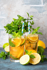 Iced tea with lemon, lime, mint and ice.