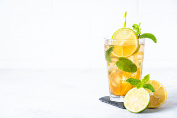 Iced tea with lemon, lime, mint and ice.