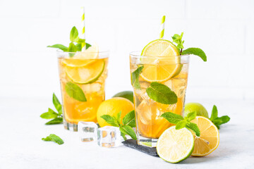 Iced tea with lemon, lime, mint and ice.