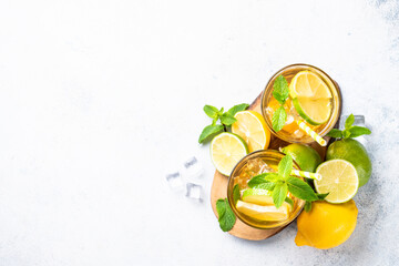 Iced tea with lemon, lime, mint and ice.