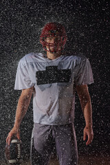 American Football Field: Lonely Athlete Warrior Standing on a Field Holds his Helmet and Ready to...