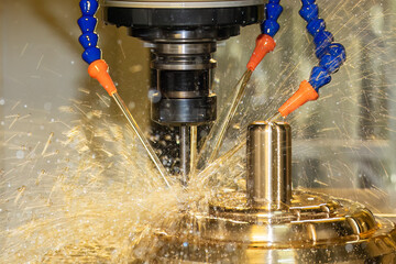 Close up scene the CNC milling machine cutting the shell mold parts with oil coolant method .