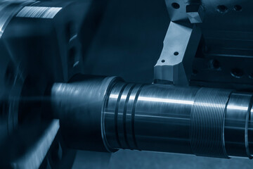 The  CNC lathe machine forming  cutting the metal shaft parts.
