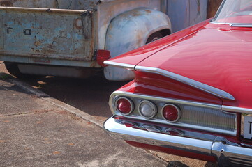 Tail Light of a 1960's Chevrolet Impala next to an old vintage Ford Pickup Truck