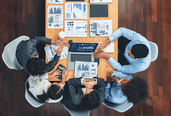 Top view multiracial analyst team use BI dashboard display on laptop screen, analyzing financial data for strategic decision. Fintech analyzes marketing indicators. Concord
