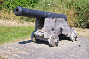 Old historic cannon with green grass in the background