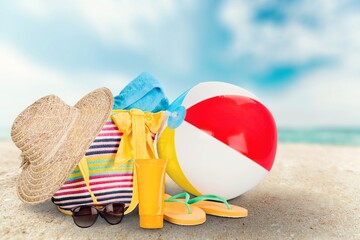 Sandy tropical beach with colored beach items, vacations concept