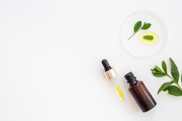 Medical herbs cosmetic background - face serum essential oil in bottle
