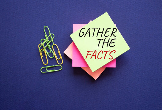 Gather the facts symbol. Yellow steaky note with paper clips with words Gather the facts. Beautiful deep blue background. Business and Gather the facts concept. Copy space.
