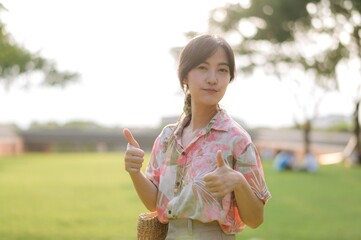 Portrait beautiful young asian woman on summer holiday vacation trip in Thailand. Young hipster female tourist sightseeing summer urban Bangkok destination. Asia summer tourism concept.