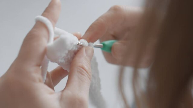 The video from above is a close-up of how the needlewoman enjoys working on her knittings, making soft yarn amigurumi, giving them a special magic and beauty. Women's hands knit various products