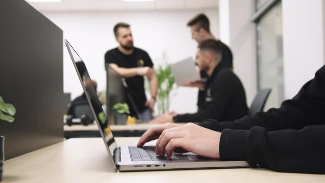 Group of businesspeople, mates involved in teamwork use laptop, look at device screen, consider new business program, corporate software, look interested, engaged in collaborative project discussion