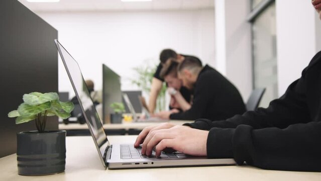 Group of businesspeople, mates involved in teamwork use laptop, look at device screen, consider new business program, corporate software, look interested, engaged in collaborative project discussion