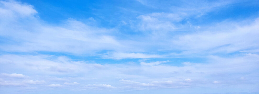 Blue sky background with white clouds. Beauty bright air background. Gloomy vivid cyan landscape.