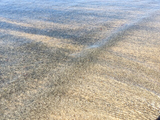 Beach wet sand texture. Sandy shore beige background.