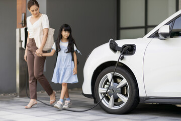 Progressive lifestyle of mother and daughter who have just returned from school in an electric...