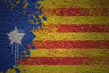 painted big national flag of catalonia on a massive old cracked wall
